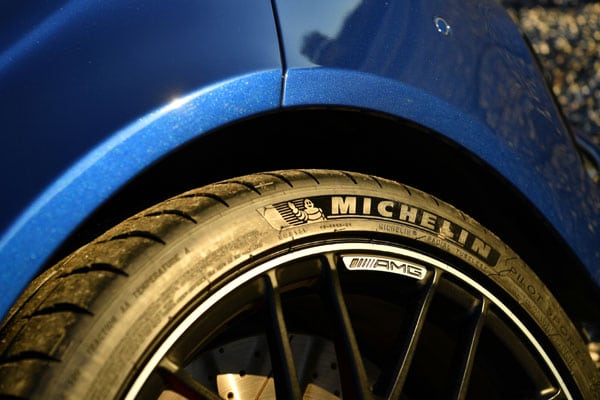 A Michelin tire attached to a blue car